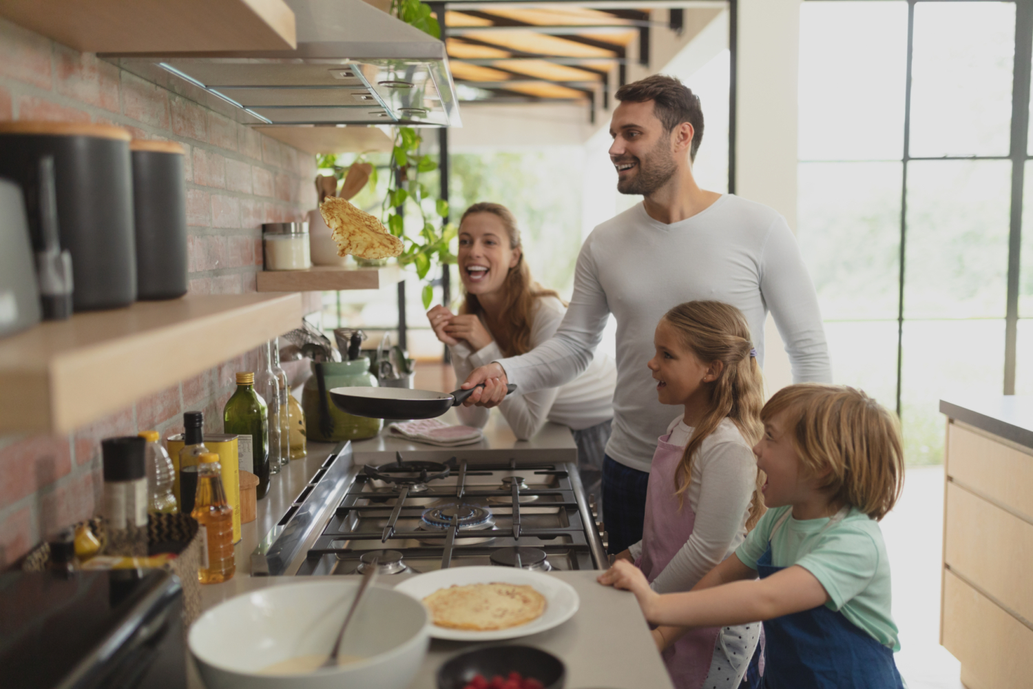 Family cooking in the kitchen with a propane range.